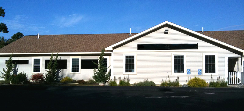 Seven ClearDome Solar BISFA)Heating panels are wall mounted on a Medical Center building in Maine